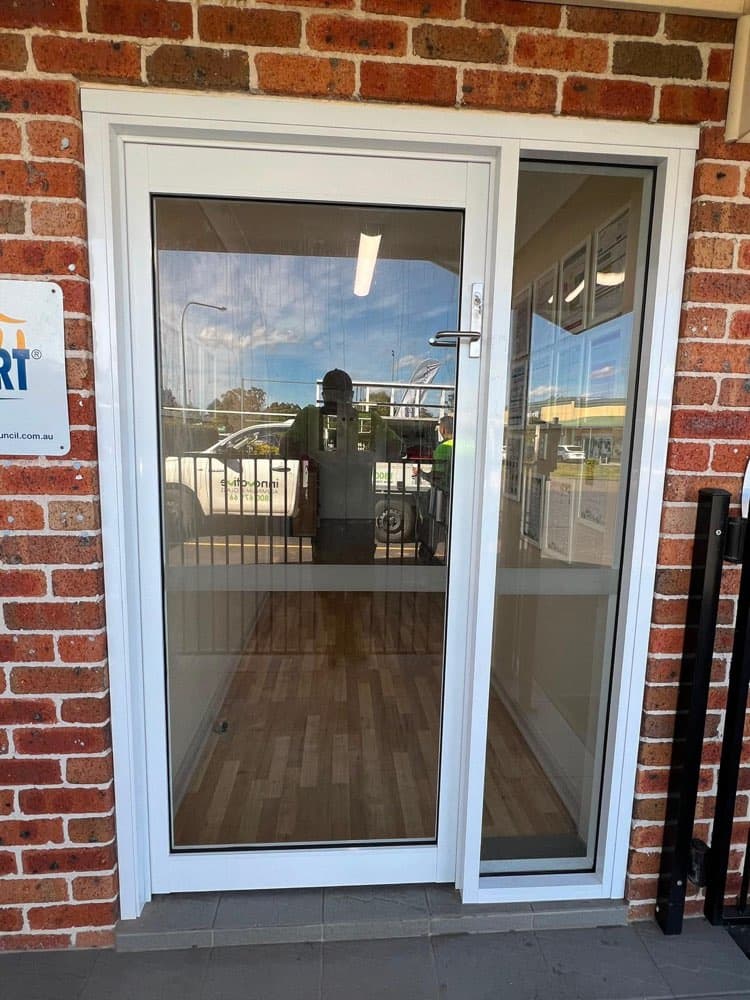 White Frame Entry Door, Red Brick Retail