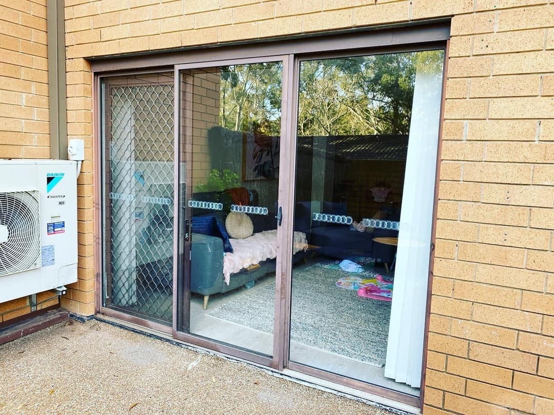 Bronze Sliding Door with Security Screen, Brick House